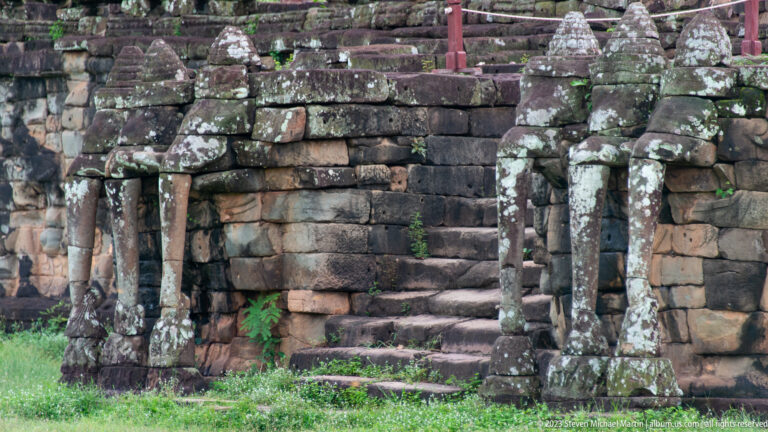Stone stair flanked by small towered posts and balustrades at Angkor Thom.
