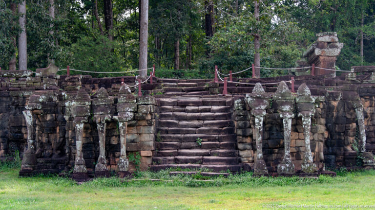 Broad frontal stair flanked by rows of guardian figures at Angkor Thom.