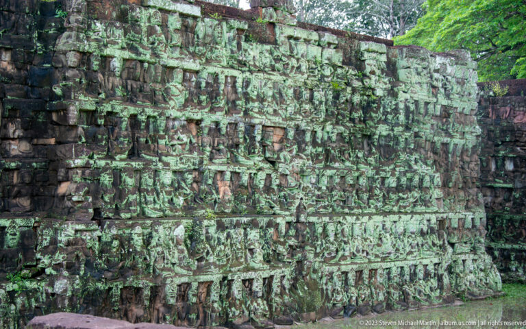 Close richly layered wall of seated and standing figures at Angkor Thom.