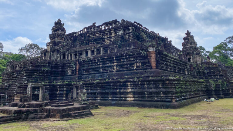 Dark stepped temple building viewed from the corner at Angkor Thom.