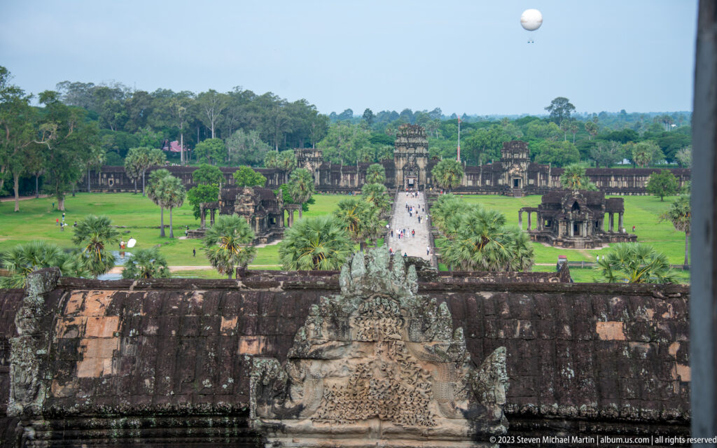 Second elevated view down the causeway with a pediment in the foreground at Angkor Wat.