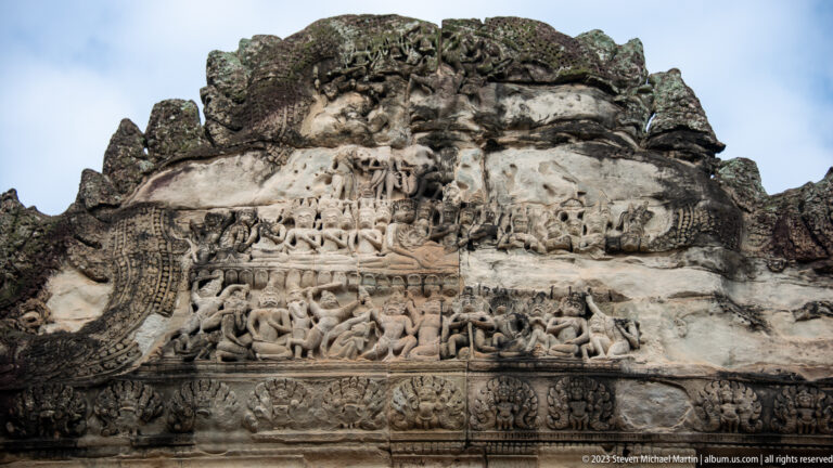 Wide pale pediment relief with several horizontal narrative registers at Angkor Wat.