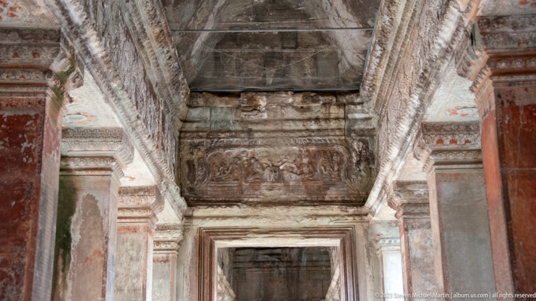 Interior doorway and ceiling with traces of red painted ornament at Angkor Wat.