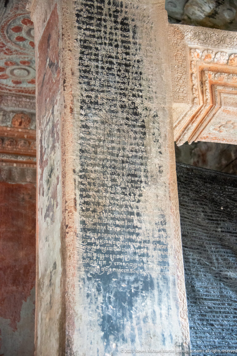 Large rectangular wall inscription containing many tightly spaced lines of script at Angkor Wat.