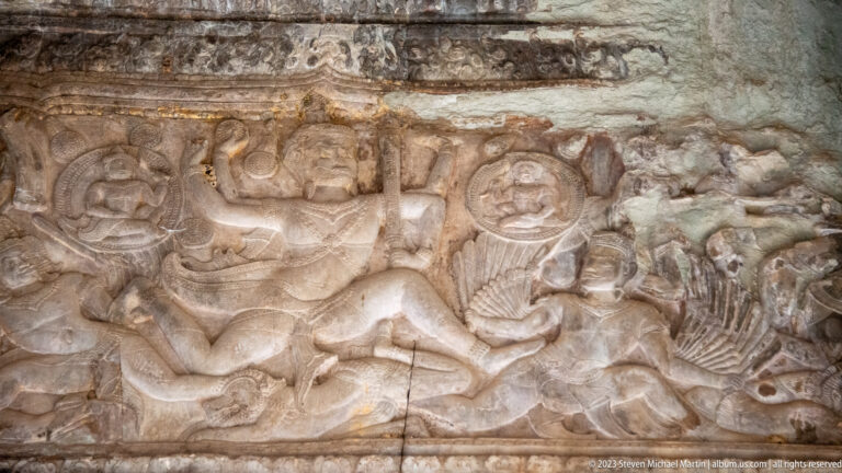 Reclining figure in a horizontal relief with attendants or animals at Angkor Wat.