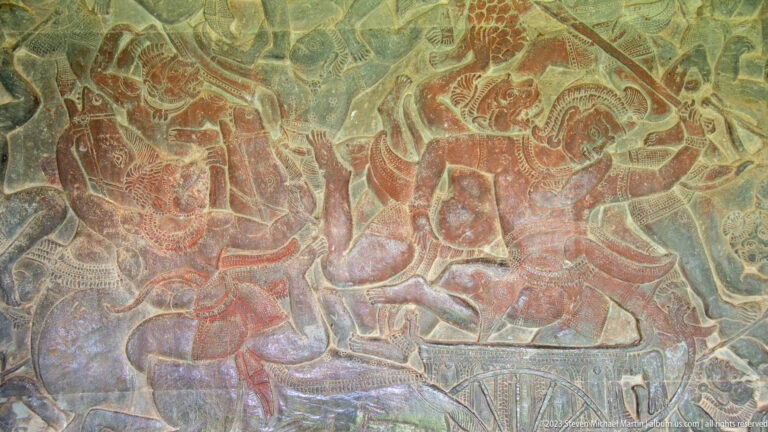 Colored narrative relief with a seated or reclining figure and attendants at Angkor Wat.