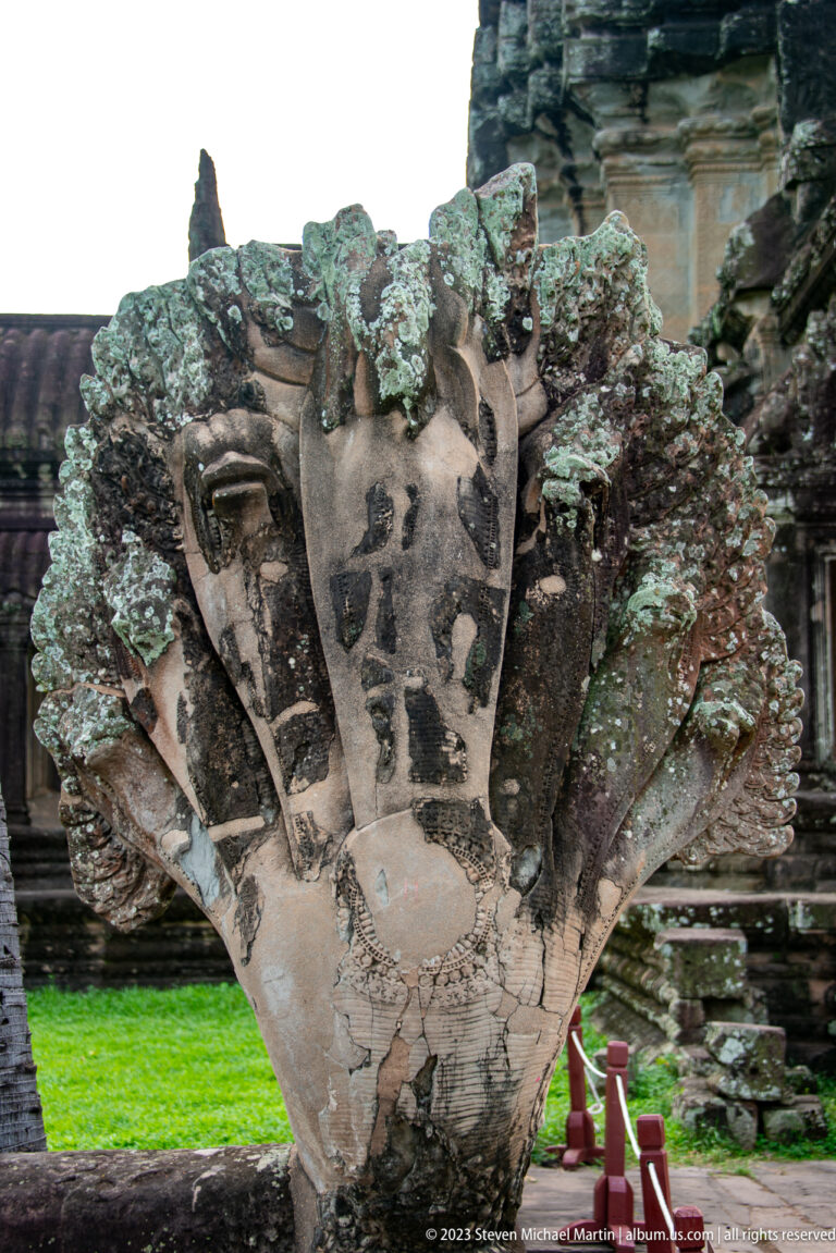 Close multi-faced or multi-headed stone figure covered with lichen at Angkor Wat.