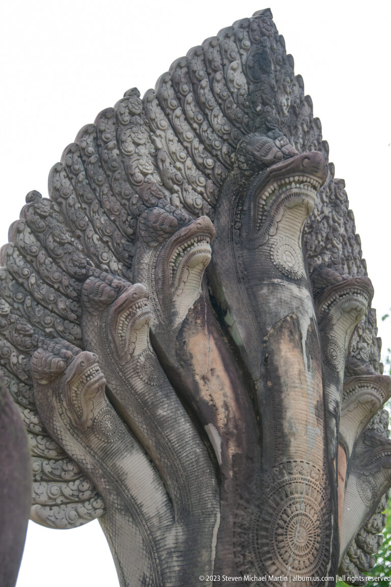 Close upward view of a multi-headed naga or clustered stone serpent hood at Angkor Wat.