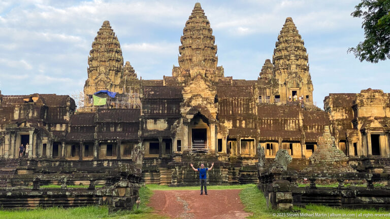 Closer warm daylight view of the three towers and central entrance at Angkor Wat.