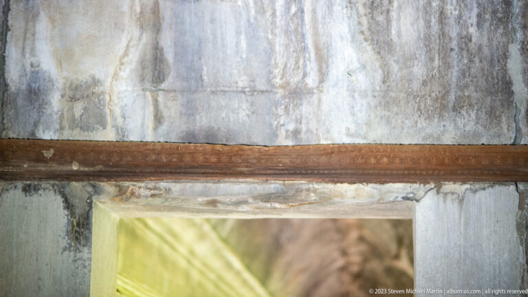 Horizontal doorway lintel or molding above a pale rectangular opening at Angkor Wat.