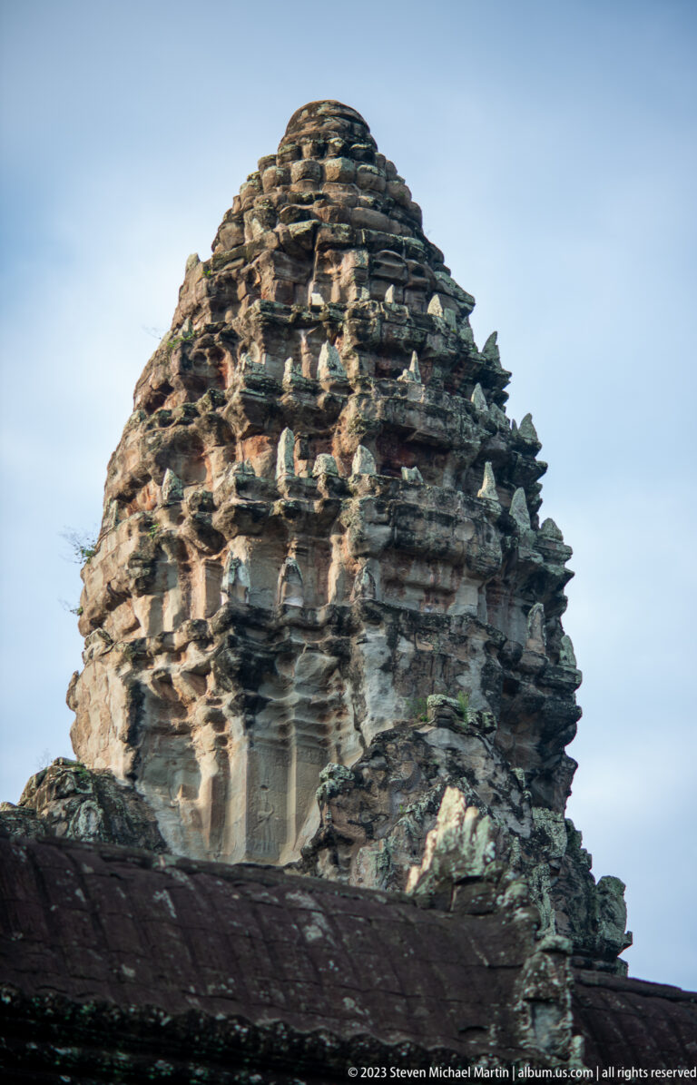 Close upward view of a weathered lotus-bud tower at Angkor Wat.
