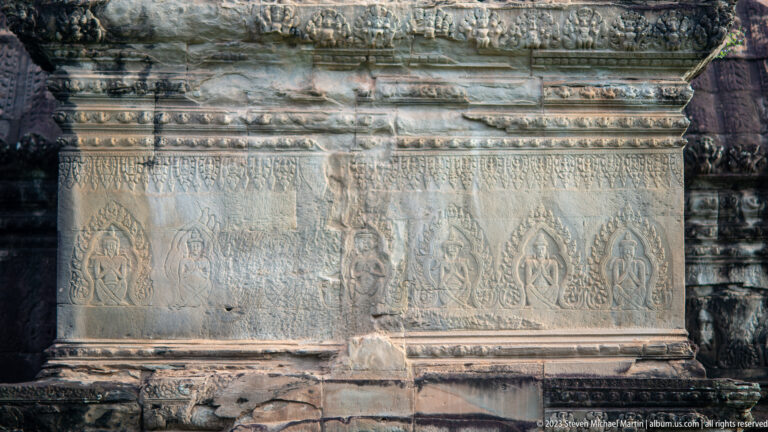 Long horizontal sandstone frieze with repeating flame-shaped foliate ornament at Angkor Wat.