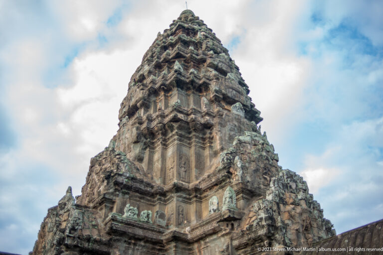 Close upward view of a weathered lotus-bud sanctuary tower at Angkor Wat.