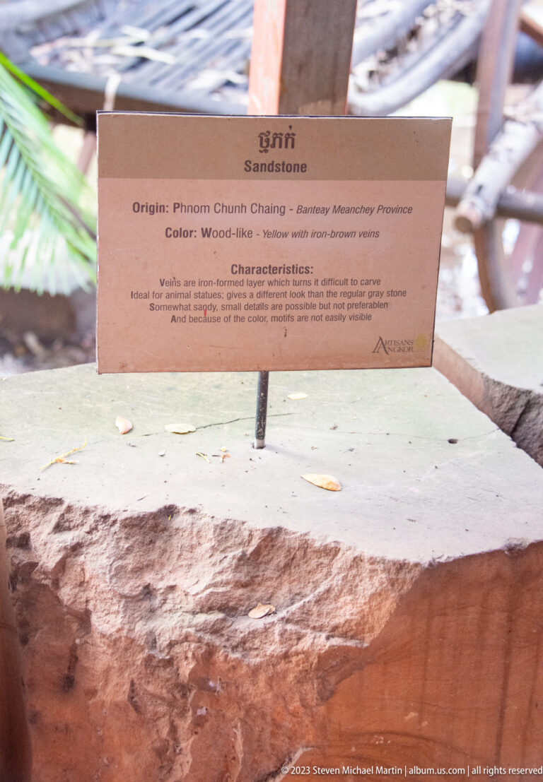 Pale stone sample beneath a sign naming Phnom Chun Chang and describing a wood-like yellow color.