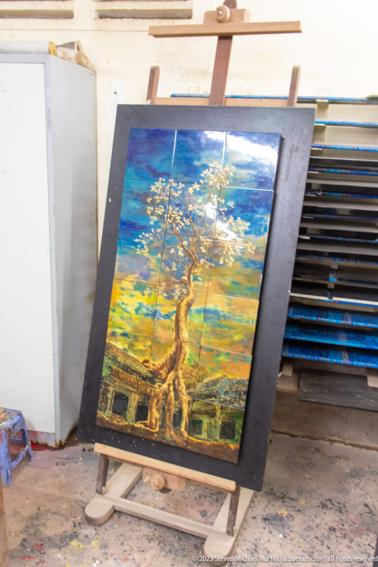 Tall decorative panel painted with a golden tree against a blue and yellow background.