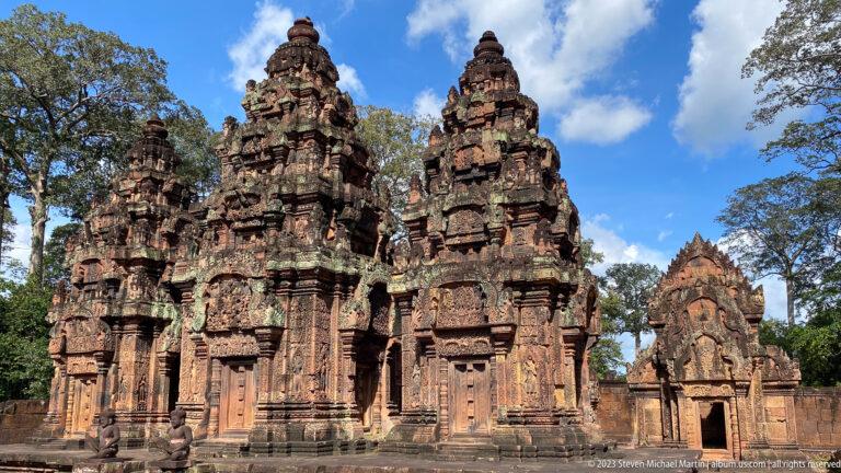 Three richly carved sanctuary towers standing together at Banteay Srei.