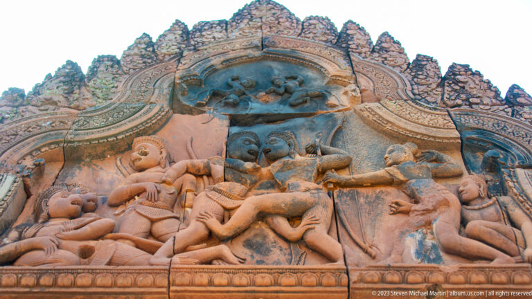 Triangular sandstone pediment crowded with figures in a dynamic mythological conflict scene.