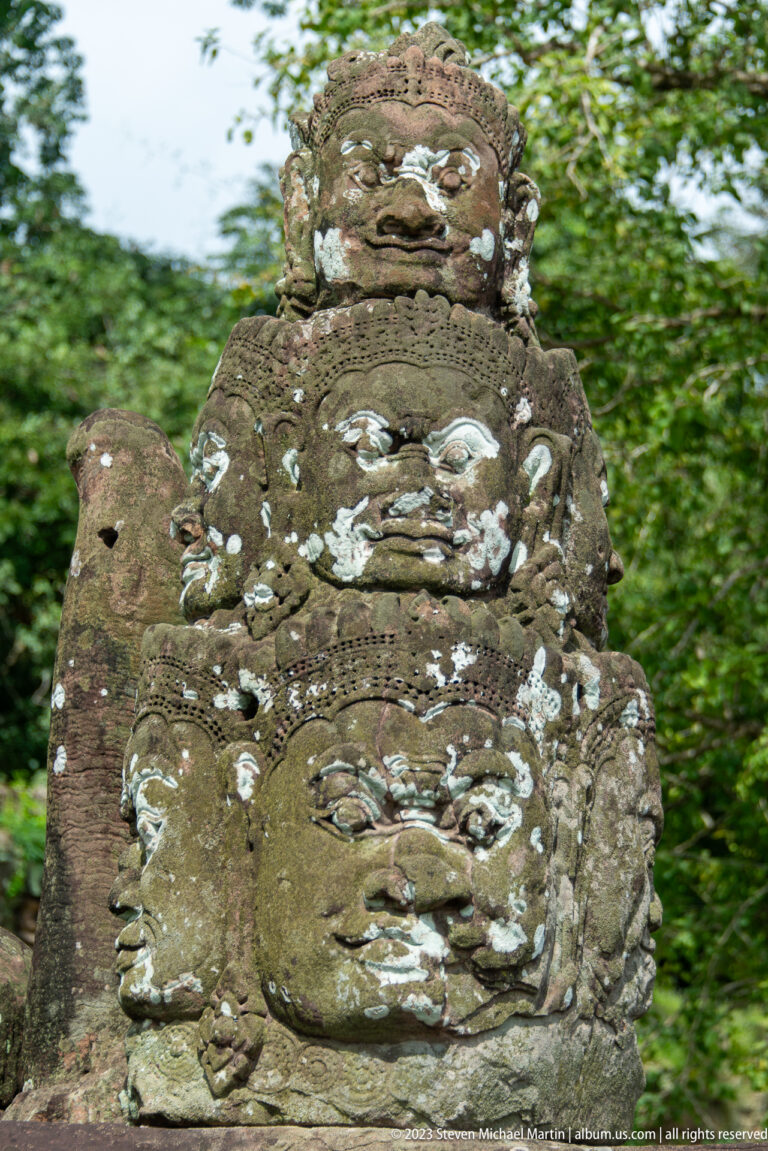 Close detail of a weathered carved face on an Angkor Thom tower.