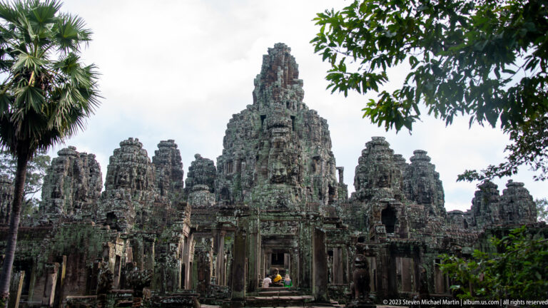 Frontal view through a doorway toward Bayon Temple's central sanctuary and clustered face towers.