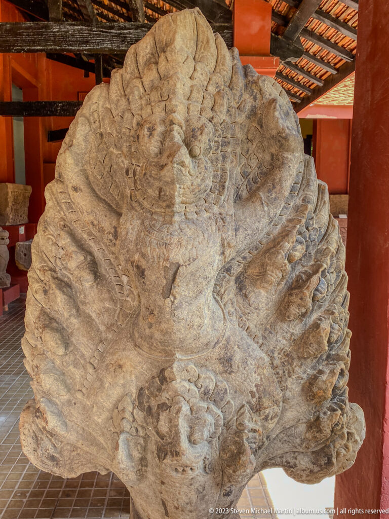 Weathered multi-headed naga sculpture displayed at the National Museum of Cambodia.