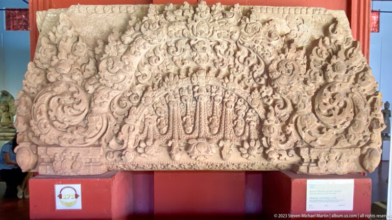 Intricately carved Khmer pediment displayed at the National Museum of Cambodia.