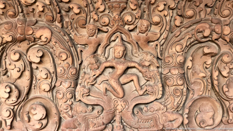 Celestial figure in ornamental relief displayed at the National Museum of Cambodia.