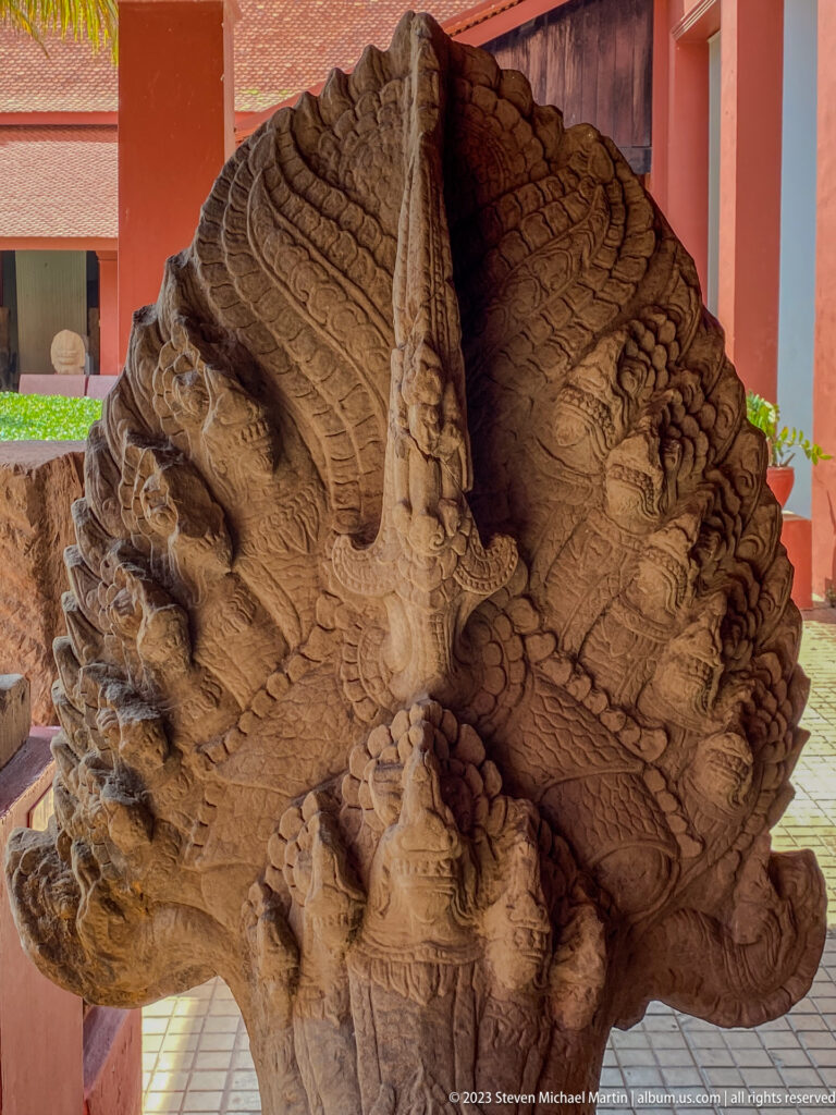 Stone naga finial displayed at the National Museum of Cambodia.