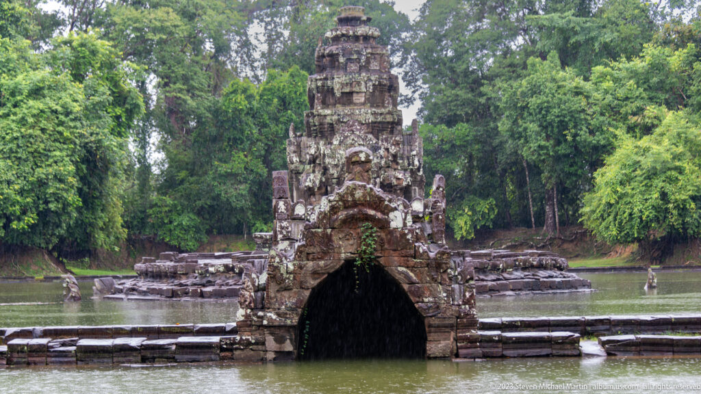 Front view of Neak Poan sanctuary beyond naga bridge.