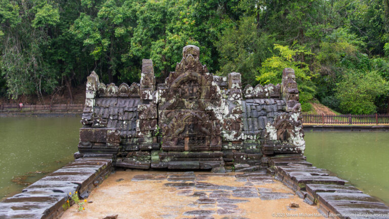 Head-on view of carved stone bridge across water.
