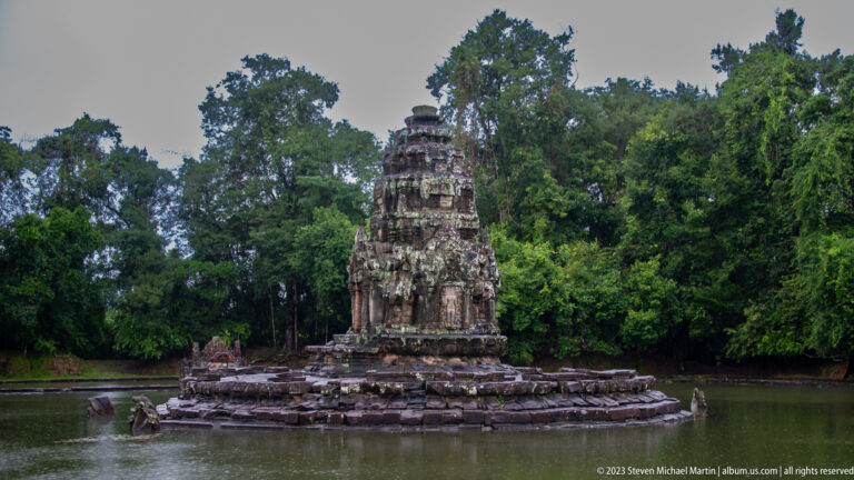 Central temple surrounded by water and trees.