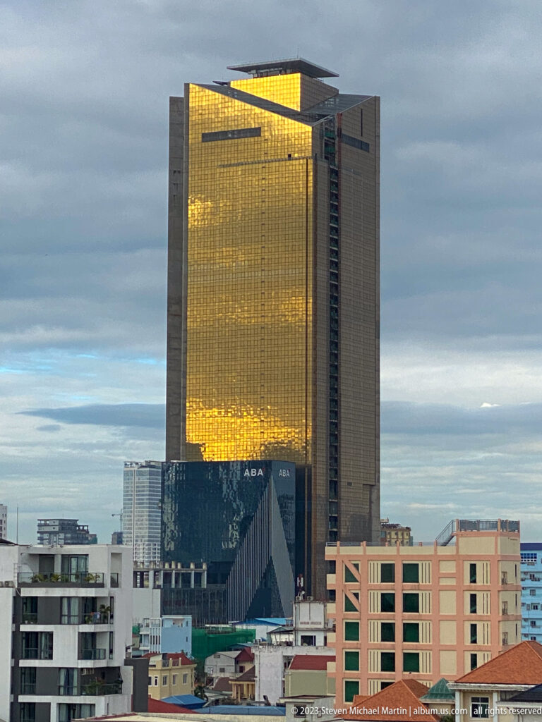 Golden-glass Vattanac Capital tower above lower buildings, with ABA Bank signage visible near the base.