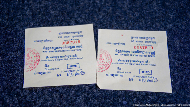 Two Wat Phnom visitor tickets printed in Khmer and English, each marked 1 USD and Foreigner Only.
