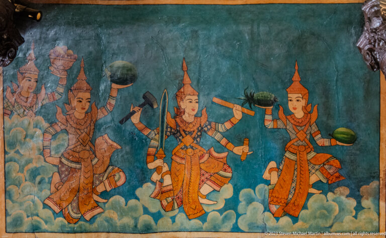 Painted crowned figures carrying weapons and offerings while moving through stylized clouds.