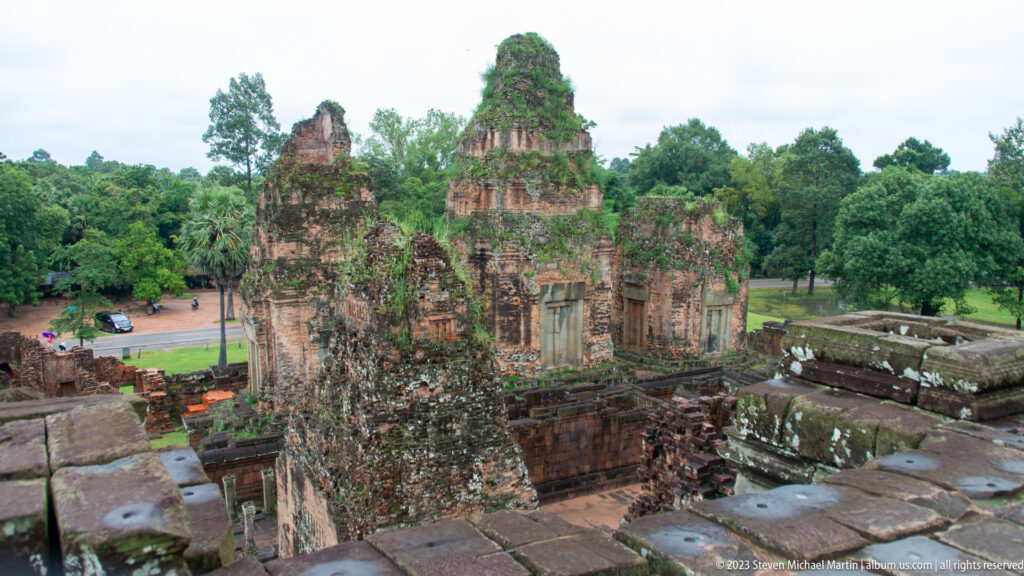 Oblique elevated view across weathered brick towers, courts, and walls at Pre Rup.