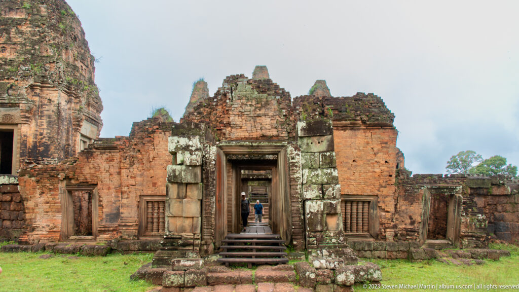 Weathered brick gateway at Pre Rup with pale sandstone blocks framing a recessed central doorway.