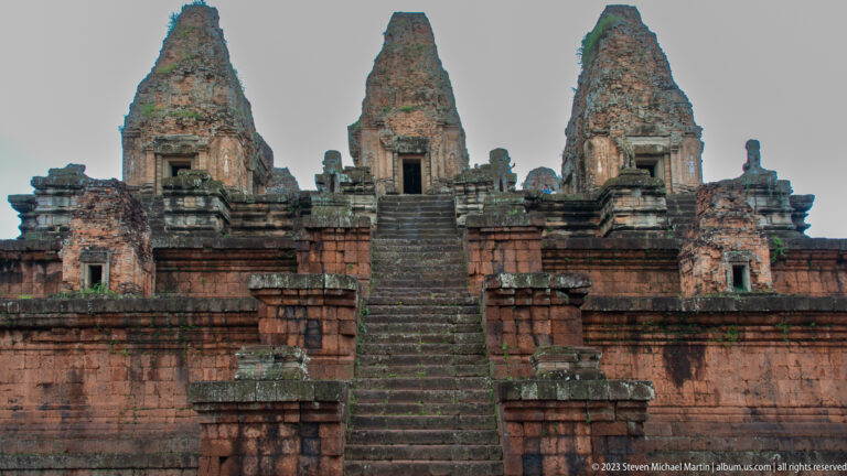 Steep central staircase at Pre Rup rising through terraced masonry toward three brick sanctuary towers.