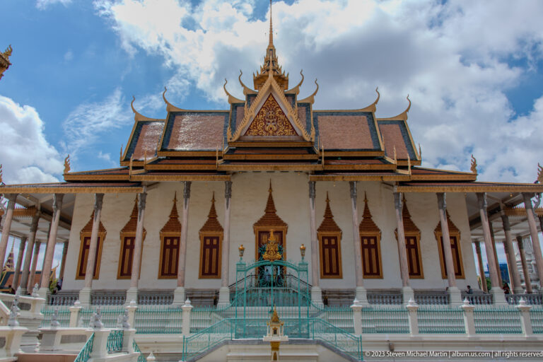Front view of the Silver Pagoda with white façade, turquoise stairs, pointed windows, columns, and gold-trimmed roof.