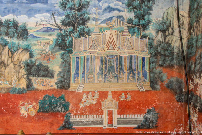 Reamker mural detail with a formal pavilion, trees, rocky landscape, and small narrative figures.