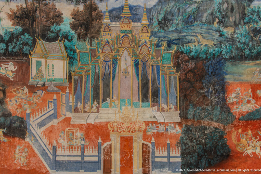 Reamker mural detail of an ornate blue, gold, green, and red palace complex within a landscape.