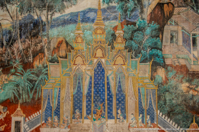 Reamker mural detail of a multi-spired palace framed by trees, smaller buildings, and figures.