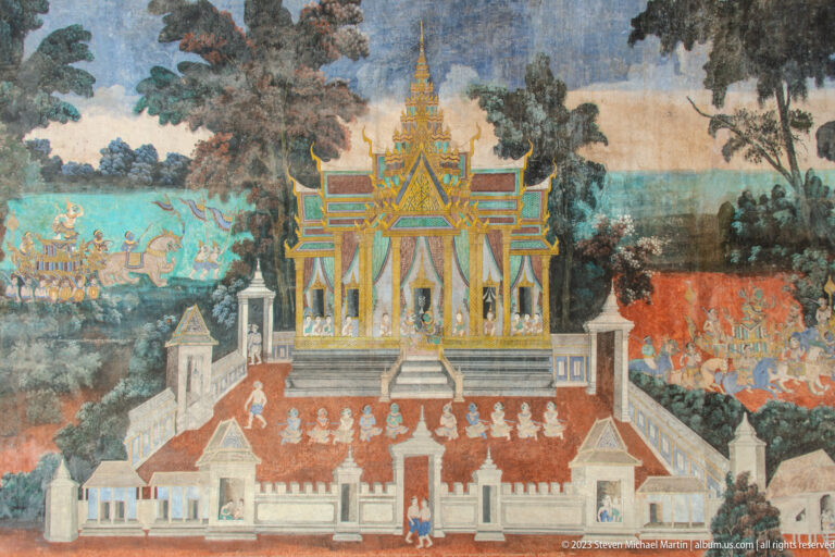 Reamker mural with a central columned palace, trees, and groups of figures in blue and red landscape zones.
