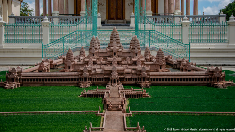 Close frontal view of the Angkor Wat model with miniature causeway, galleries, central towers, and palace railings behind.