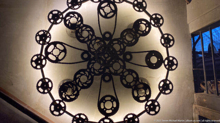 Decorative chandelier made from gear-shaped metal rings.