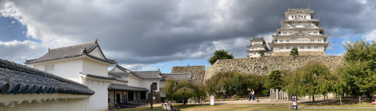 White plaster walls leading toward the keep