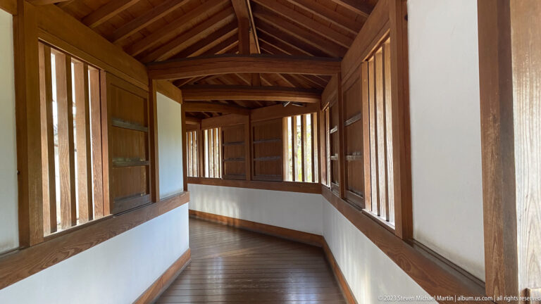 Wooden passage with repeating window bays