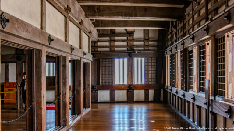 Wooden interior room with beams and polished floor inside Himeji Castle.
