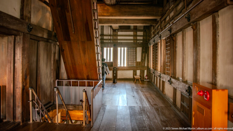 Historic wooden stair landing inside Himeji Castle.