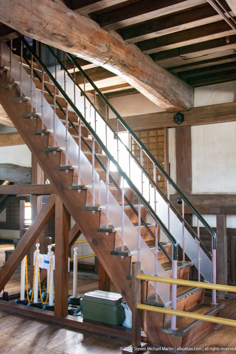 Broad timber staircase inside Himeji Castle.