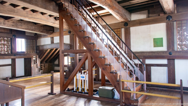 Wooden staircase and surrounding gallery inside Himeji Castle.