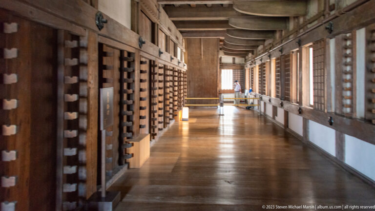 Long wooden gallery with timber posts inside Himeji Castle.